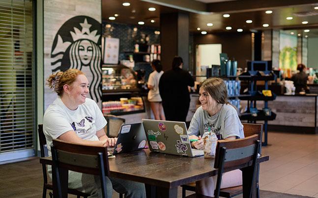 two students at Starbucks inside the Student Center