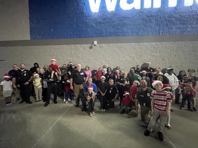 Shoppers pose for a photo with members from the SFA University Police Department