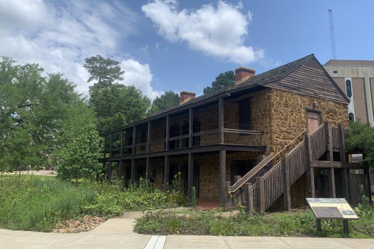 The Stone Fort Museum is pictured with surrounding greenery.