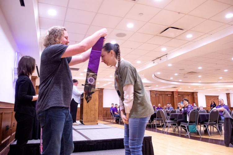 Evelyn McAdam, a Marine veteran graduating magna cum laude with a Master of Arts in photography, is given her graduation stole during Stephen F. Austin State University’s inaugural Veterans Resource Center graduation luncheon Wednesday, May 3.
