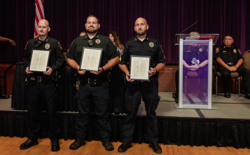 Stephen F. Austin State University’s police department, Officer Elijah Lenderman, Corporal Ian McDonald and Corporal Justin Henderson, were presented letters of commendation July 10 in recognition of their life-saving response to a Rave Guardian application call.  