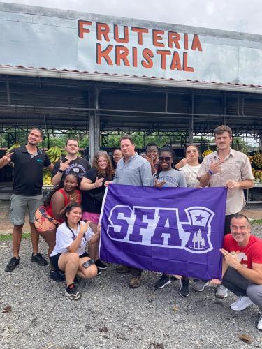 SFA students in Costa Rica standing in front of Frutería Kristal in Guápiles