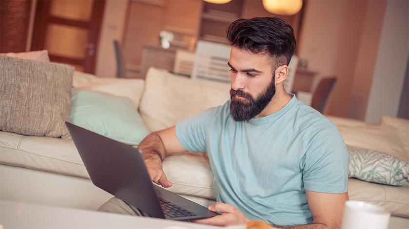 man watching a webinar on his laptop 