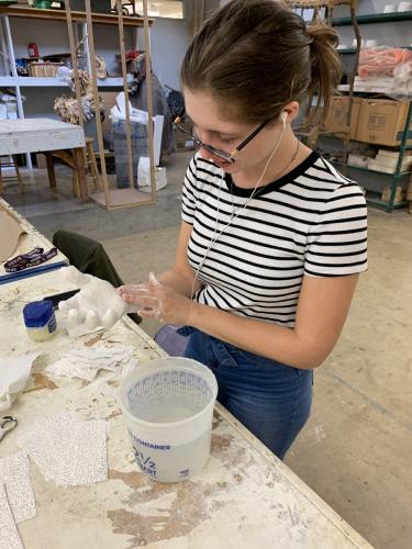 SFA School of Art student Emily Gilbert of Mabank works on a sculpture