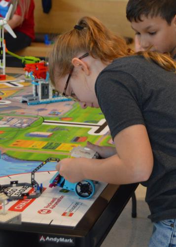 elementary students working on a Lego project