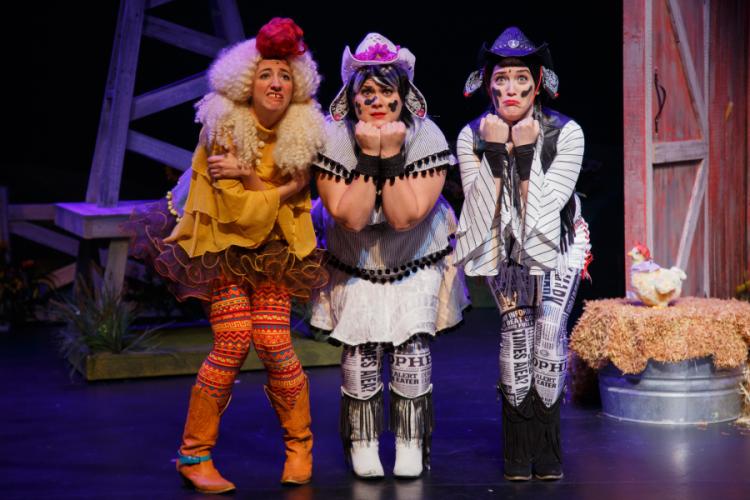 photo of women in cow costumes on the set of the production of "Click, Clack, Moo: Cows That Type"