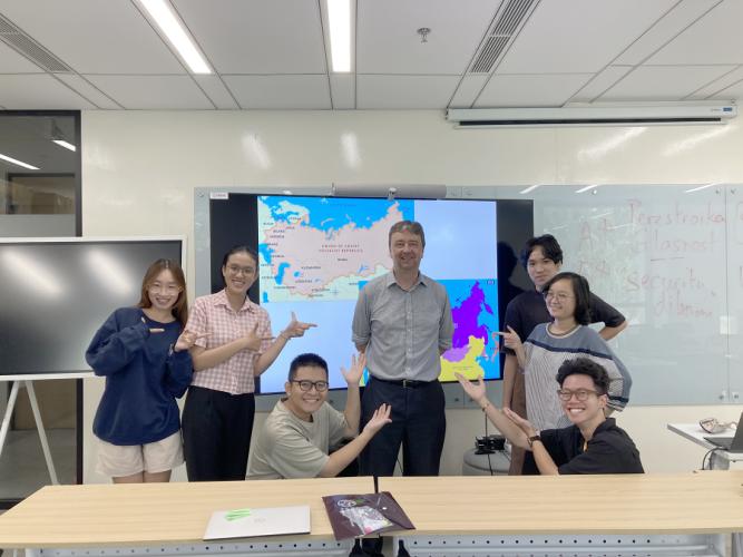 Dr. Philip Catton poses for a photo with students at Fulbright University Vietnam in Ho Minh City, Vietnam