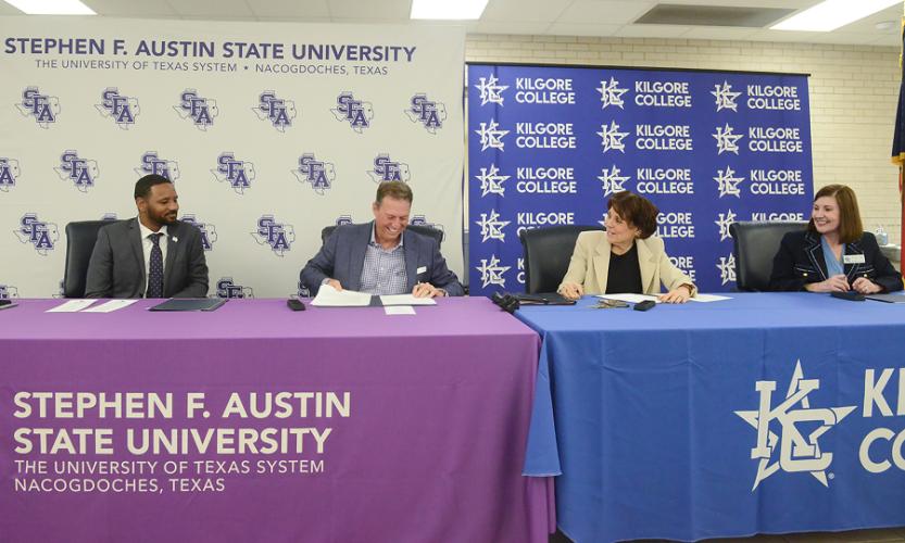 Dr. Kent Willis, Dr. Neal Weaver, Dr. Brenda Kays and Dr. Tracy Skopek are pictured together at a table during the the Lumberjack Transfer Alliance agreement signing