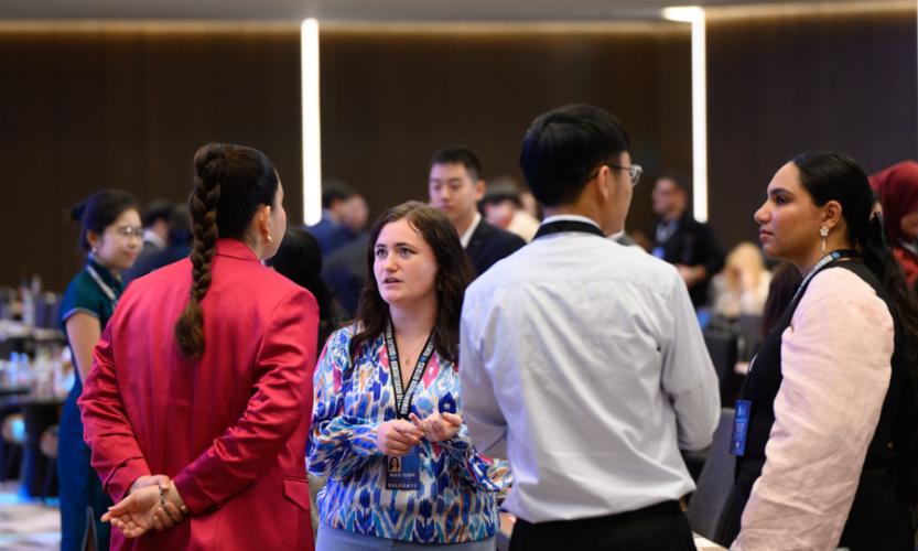 Kacie Clopp speaks with other scholars attending the 13th annual University Scholars Leadership Symposium in Kuala Lumpur, Malaysia