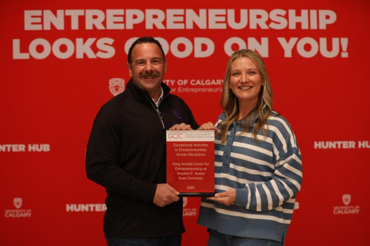 Matt Smilor, ACE director, and Dr. Hollie Gammel Smith, ACE executive director of community partnerships, accepting the award