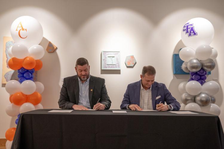 Dr. Michael Simon and Dr. Neal Weaver sign a partnership agreement launching Jacks Jumpstart