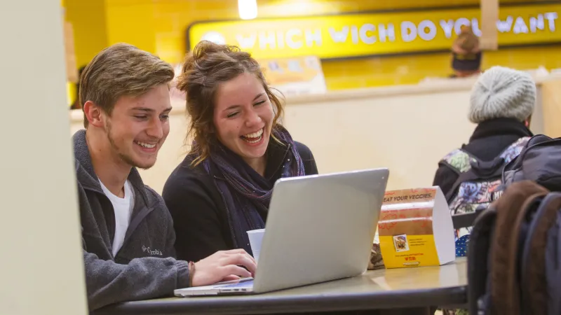 Students working at computer in restaurant