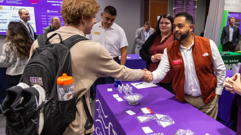 Student shaking hands with prospective employer