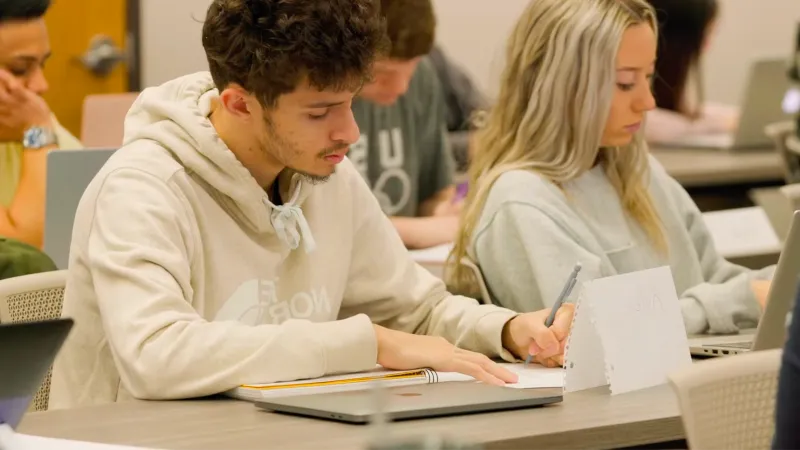 Student takes notes in class