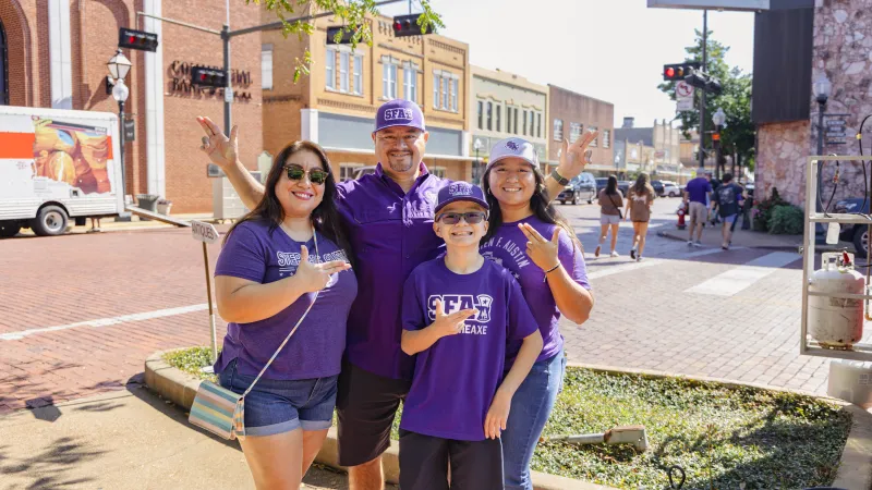 SFA family smiling downtown