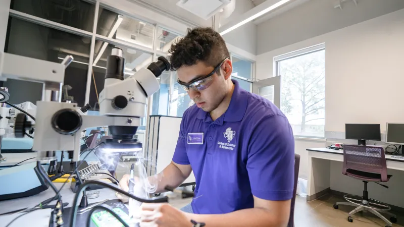 Student using a microscope