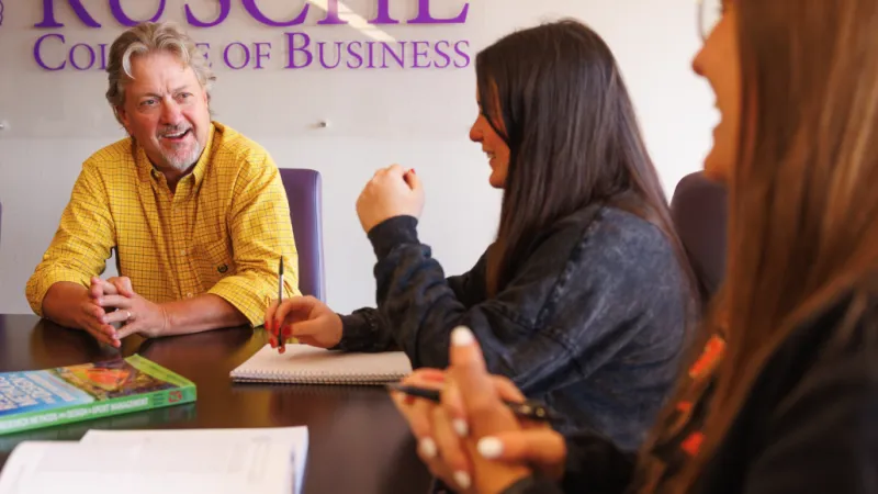 Faculty member talking to students