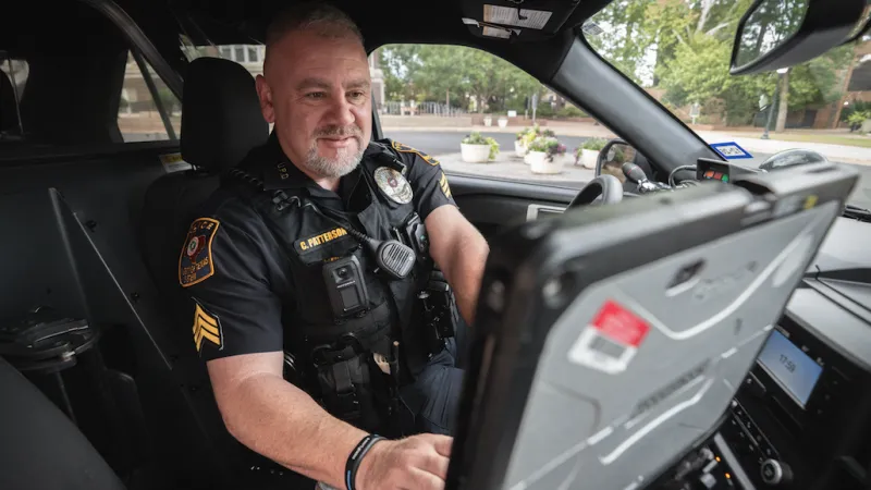 police officer using computer in their car