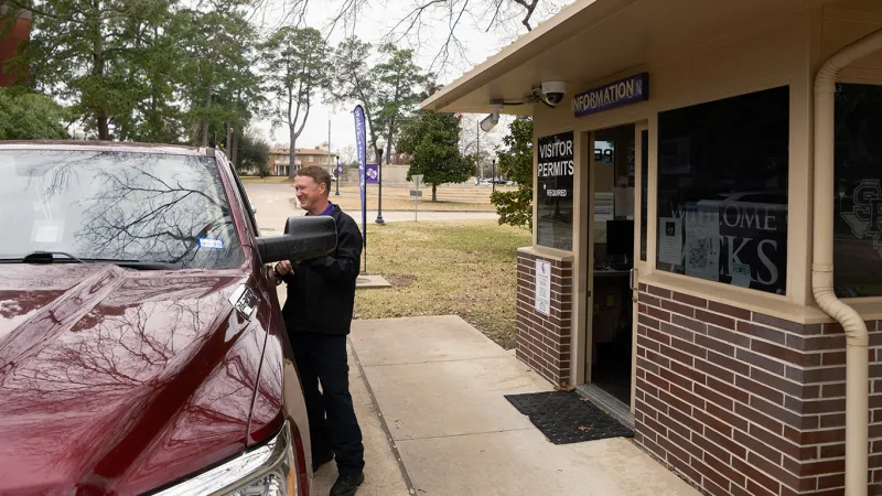 Parking Services employee assisting campus guest