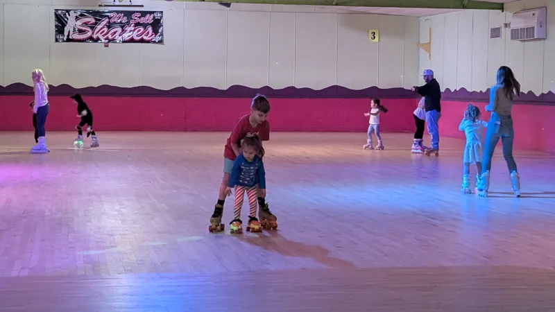 families skating at the roller rink
