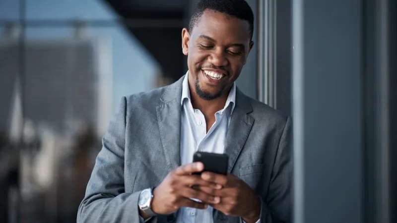 Man, phone and happy in office for professional career