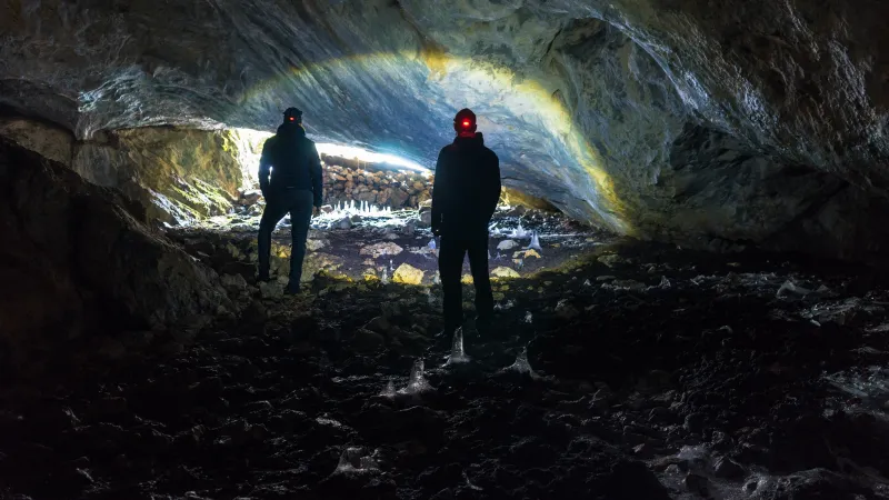 two people exploring a cavern