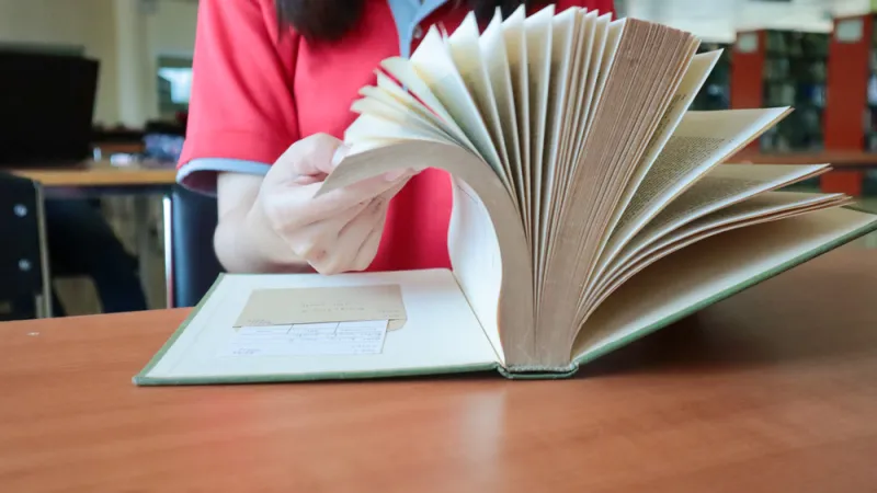 Closeup of person flipping through a book