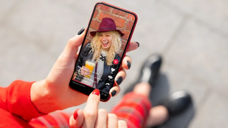 Woman viewing social media content on mobile phone