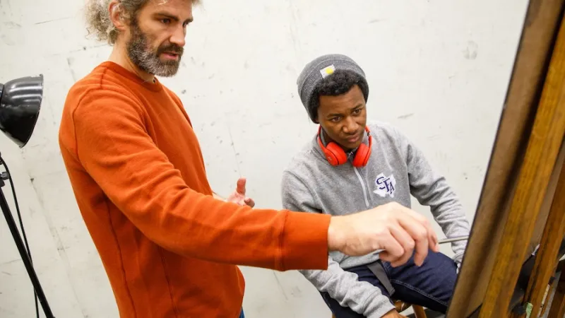 Instructor critiquing student's work