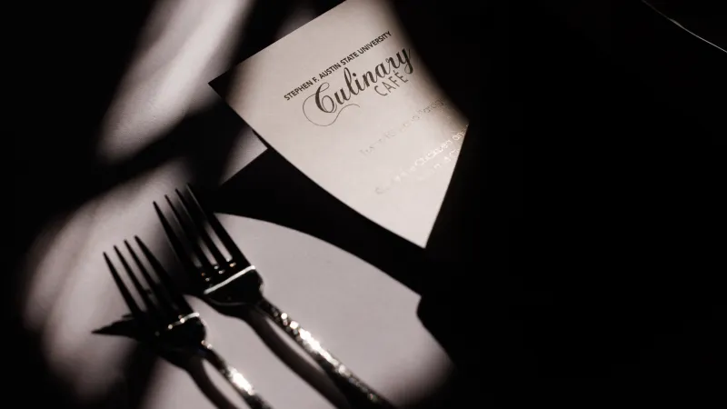 Closeup view of a Culinary Cafe menu and forks