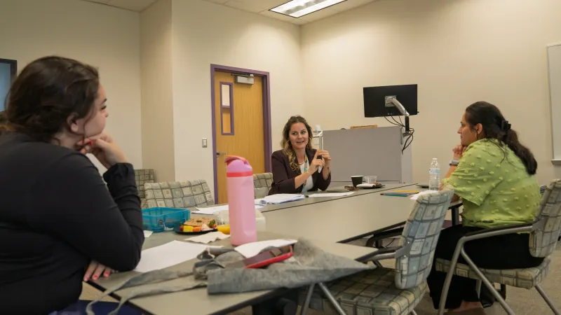 Teachers sitting around a desk collaborating
