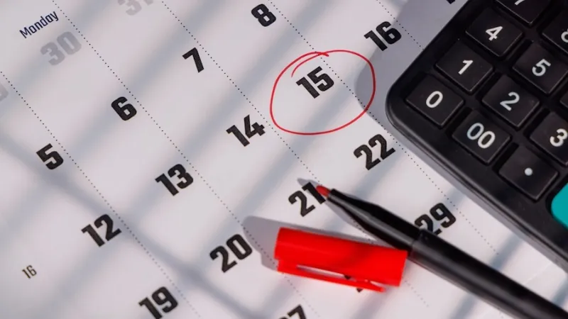 Closeup of a calendar with the 15th circled in red