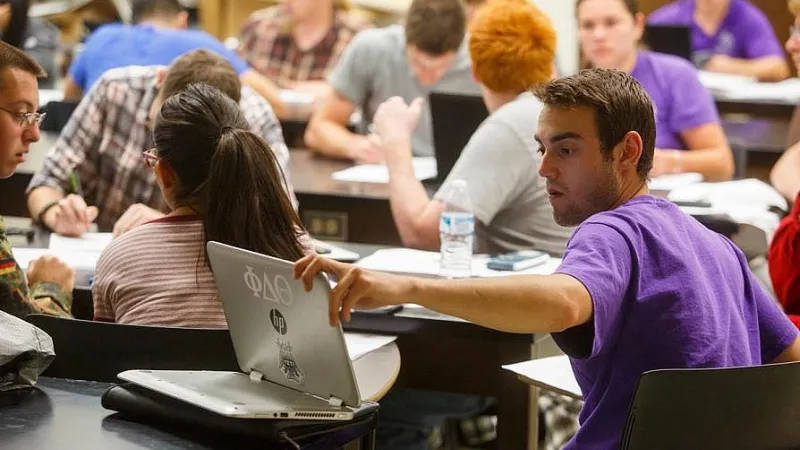 Student in class using their laptop