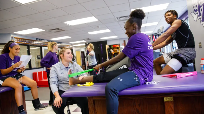 Students stretching calf muscles