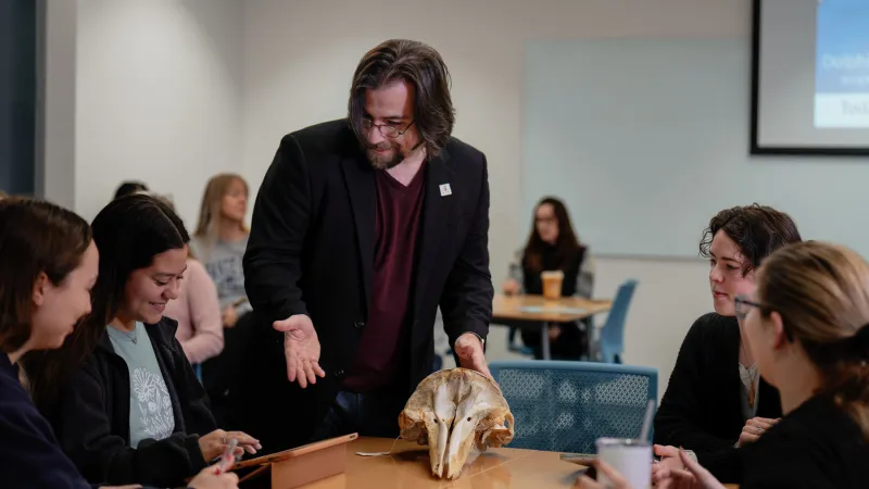 Dr. Jason Bruck shows students a dolphin skull