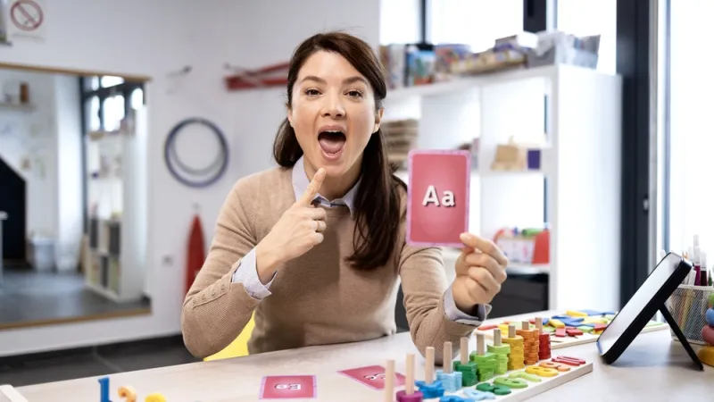 Instructor showing how to pronounce A