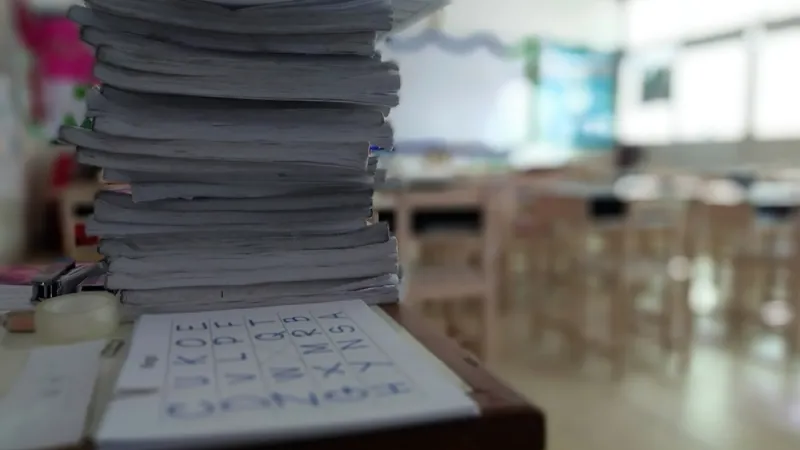 stack of papers on teachers desk 