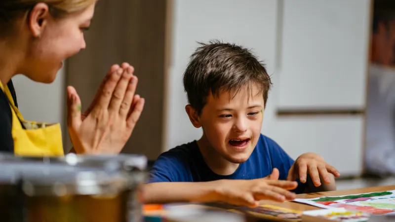 teacher clapping for young student's accomplishment