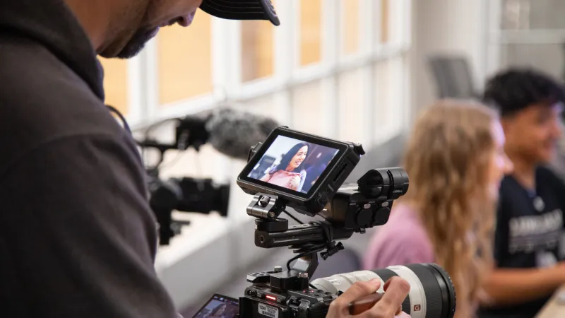 behind the scenes view of videographer's camera