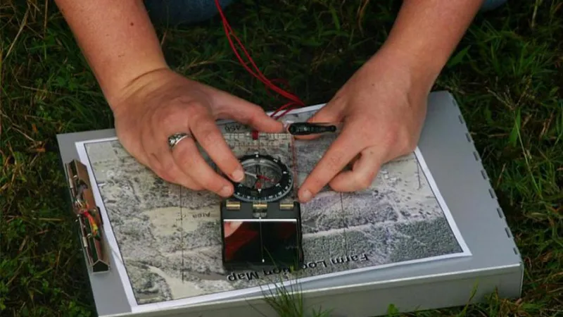 person using tools to mark map