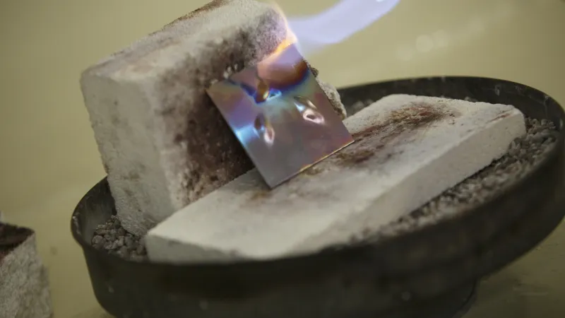 Using a torch to heat a piece of metal