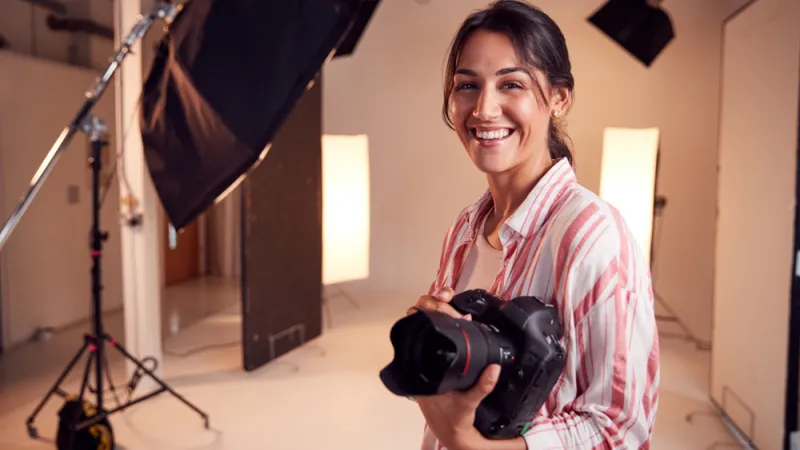 Female Photographer Standing In Studio
