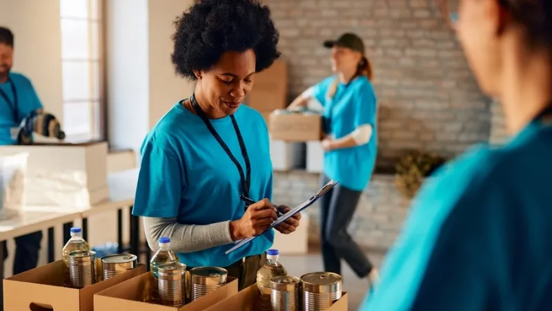 Female community services manager checks inventory at food back donation center
