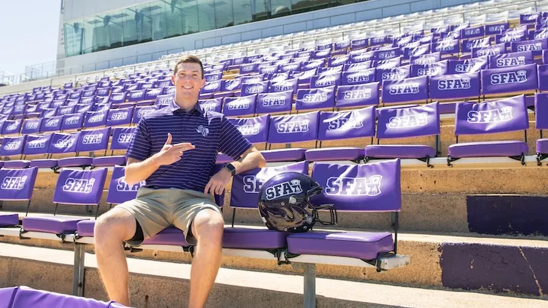 Student sitting in the stands at Homer Bryce Stadium