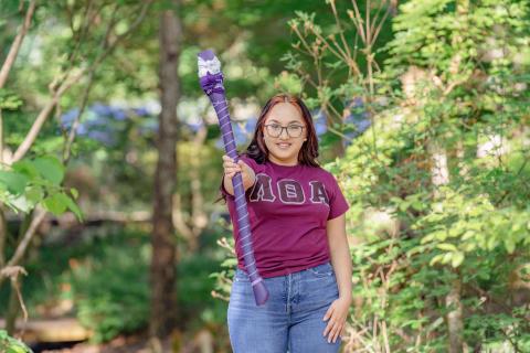 student holding axe handle