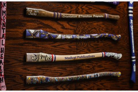 axe handles displayed on wall