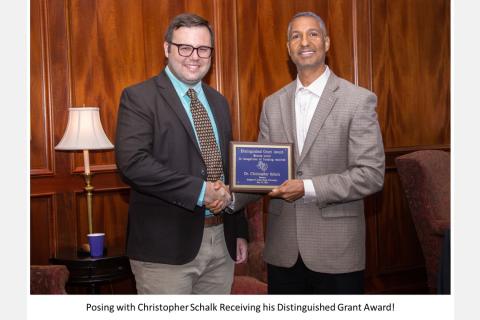 posing with Christopher Schalk receiving his distinguished grant award