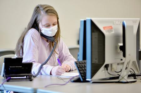 Before graduating in May, Ashleigh Ahlborn volunteered at the call center. Following Centers for Disease Control and Prevention guidelines, Ahlborn asked callers basic information like name and date of birth before progressing to more specific questions relating to signs and symptoms, travel history and exposure to illness.