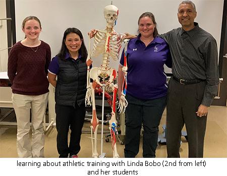 learning about athletic training with Linda Bobo (2nd from left) and her students