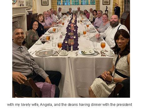 with my lovely wife, Angela, and the deans having dinner with the president